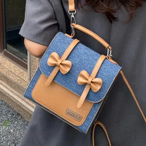 Retro denim and brown leather patchwork backpack for women with bow decoration