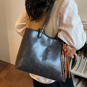 Retro large capacity leather tote bag in dark grey with stylish shoulder strap and charm
