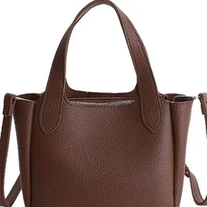Dark brown leather bucket bag with lychee texture and dual handles for daily commute