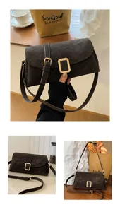 Detail of dark brown suede square bag showing the gold metal buckle and adjustable strap