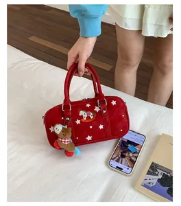 Detail of red Boston bag with star patterns and a cute plaid horse charm accessory