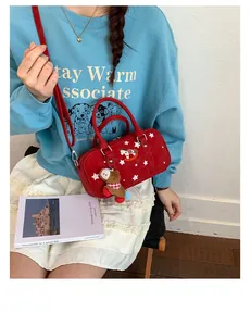 Detail of red Boston star bag featuring bear charm and horse print on model