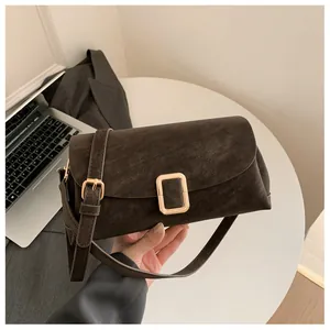 Detail of vintage coffee brown crossbody bag with gold metal buckle for office use