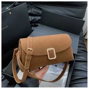 Brown suede square shoulder bag shown with premium gift box and gold hardware detail