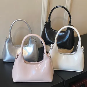 Glossy hobo bags in silver black pink and beige colors with polished metallic zippers