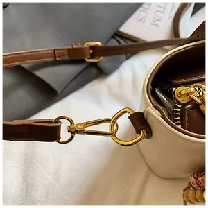 Details der goldfarbenen Hardware und Nähte an der zweifarbigen Umhängetasche für Damen