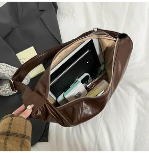 Deep brown PU leather crescent bag interior showing high storage capacity for daily essentials