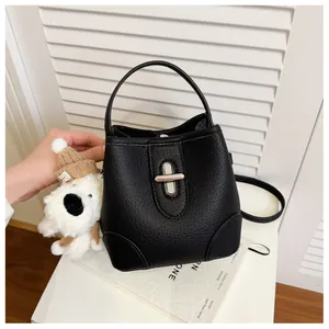 Detail of black lychee grain bucket bag featuring silver twist lock and puppy charm