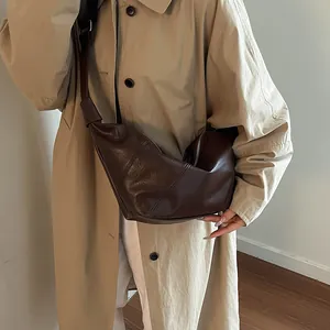 Minimalist dark brown crescent crossbody bag for women with stylish pleated leather design