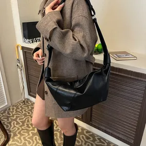 Retro black faux leather crescent shoulder bag with adjustable strap and zipper closure
