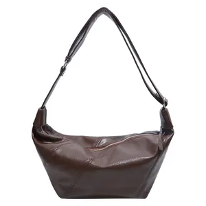 Dark brown faux leather hobo shoulder bag with stitching and adjustable strap