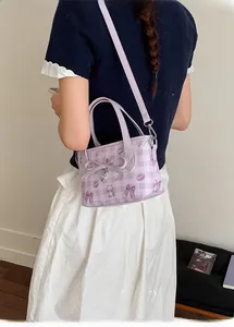 Detail of lavender cartoon bucket bag with heart pendant and cute bear prints
