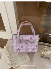 Detail of light purple checkered bucket bag with cute cartoon prints and bow heart pendant
