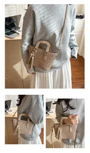 Detail view of beige pleated bucket bag with wavy texture and matching tassel charm