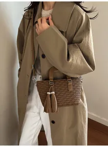 Deep brown pleated bucket bag detail with twin tassel charms and silver rhinestone accents