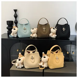 Detail of five multi-colored leather bucket bags with silver locks and plush charms
