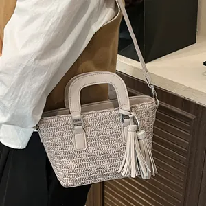 Minimalist beige pleated bucket bag with rhinestone tassel charms and crossbody strap