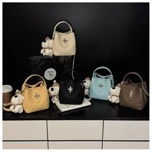 Multiple bucket bags in five colors featuring metallic twist locks and cute puppy charms