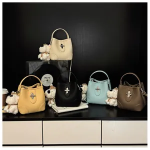 Detailed view of bucket bags in five colors with cute plush dog charms and silver locks