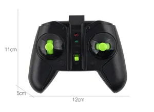 Detailed view of black remote controller with green joysticks for stunt toy car, 11x12cm