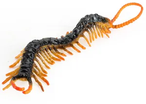 Detailed close-up of realistic centipede toy model with black body and yellow legs