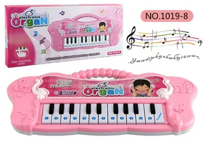 Pink electronic keyboard for kids with handle and packaging in a clean white background
