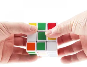 Detailed shot showing a 58mm 3x3x3 speed cube with smooth rotation in hands