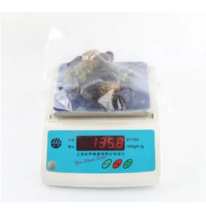 Mini gorilla action figure in plastic packaging showing weight of 35.8g on scale