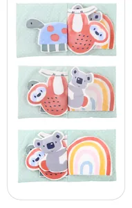 Detail showing soft fabric pages of the baby cloth book with cute animal embroidery