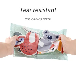 Close-up of tear resistant fabric book for babies with cute sloth and koala patterns