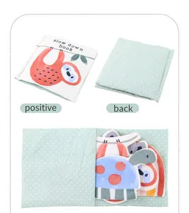 Detail showing the plush baby sensory book with 3D animal parts and crinkle paper textures
