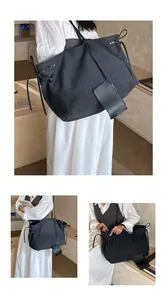Detail of black canvas tote bag featuring decorative drawstring bows and a small pouch