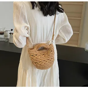 Detail of hand-woven cotton rope bucket bag with semi-circular handles and strap