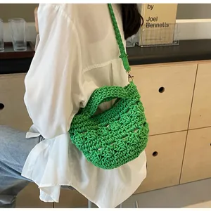 Close-up of bright green handmade woven bucket bag with detailed mesh texture and strap