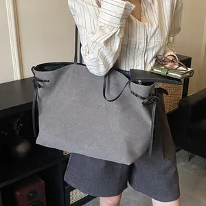 Large dark grey canvas tote bag with black leather straps and matching zip pouch