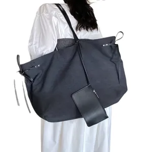Minimalist black large capacity canvas tote bag with leather straps for daily commuting