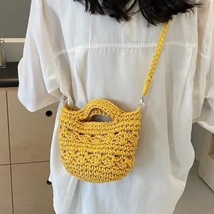 Handmade yellow crochet beach bucket bag with long shoulder strap for summer vacation