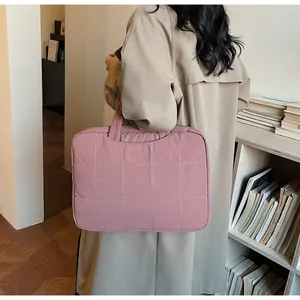 Close-up of quilted dusty rose laptop bag with soft padded texture for daily use