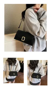 Detail view of black matte pillow bag featuring a stylish gold rectangular buckle and strap