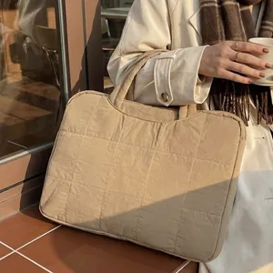 Beige quilted laptop sleeve tote bag with minimalist square pattern for daily commute