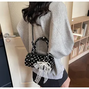 French vintage polka dot barrel bag with a lace bow and pearl chain details