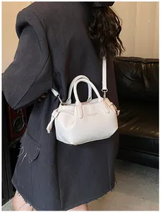 Detail of white litchi pattern leather tote bag with FASHION & BAGS logo on the front