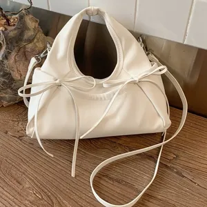 Minimalist beige bow-knot cloud bag with pleated handles and a detachable shoulder strap