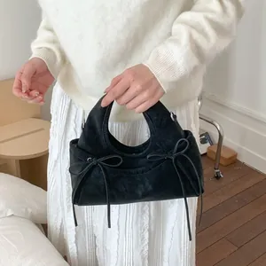 Fashionable black suede cloud handbag with elegant bows and retro stylish handle design