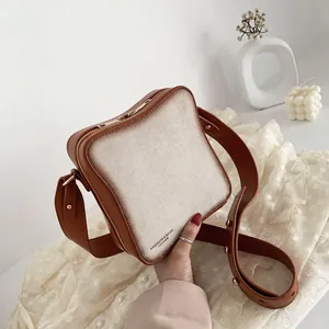 Unique toast bread shaped crossbody bag with brown leather trim and wide shoulder strap