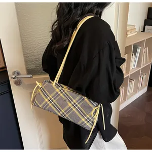 Classic checkered baguette bag shoulder carry view with yellow leather strap