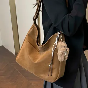 Grand sac hobo marron minimaliste avec charm d'ours et détails de coutures en V