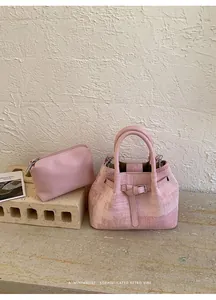 Pink retro bucket bag with matching inner pouch showing vintage washed leather texture