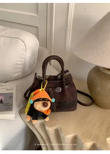 Retro dark brown plaid bucket bag featuring a cute plush dog charm and leather handle