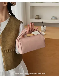 Close-up of elegant lychee pattern texture on a pink cylindrical handbag for women